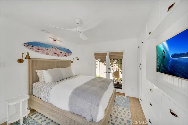 a bedroom with a bed and a mirror on the dresser