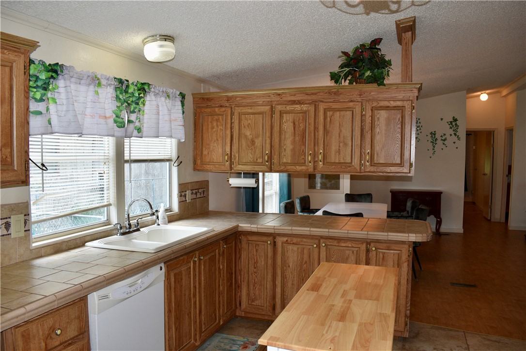 25051 Lake Shore Drive Mathis, TX 78368 - Photo 9 of 40 a kitchen with stainless steel appliances granite countertop a sink stove and cabinets