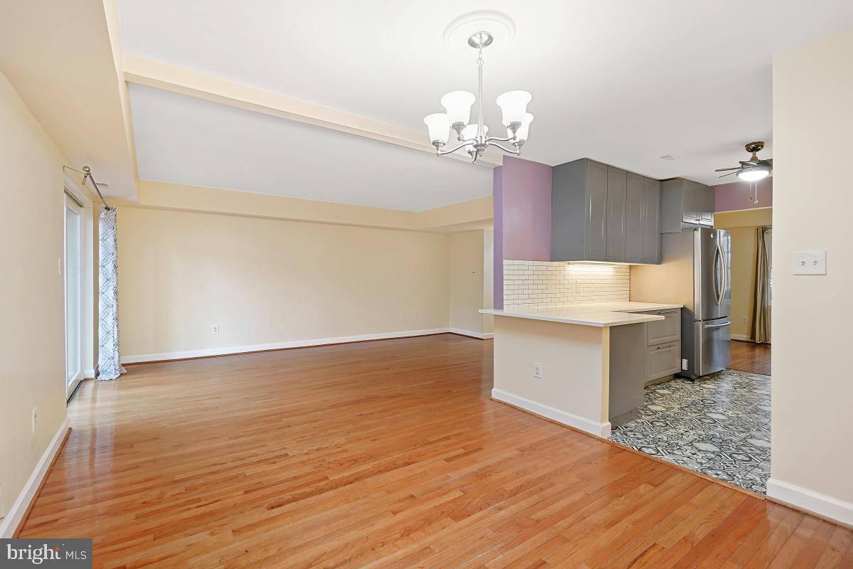 10867 Bucknell Drive, Unit 52 Silver Spring, MD 20902 - Photo 13 of 33 a view of a kitchen with a sink dishwasher a refrigerator and wooden floor
