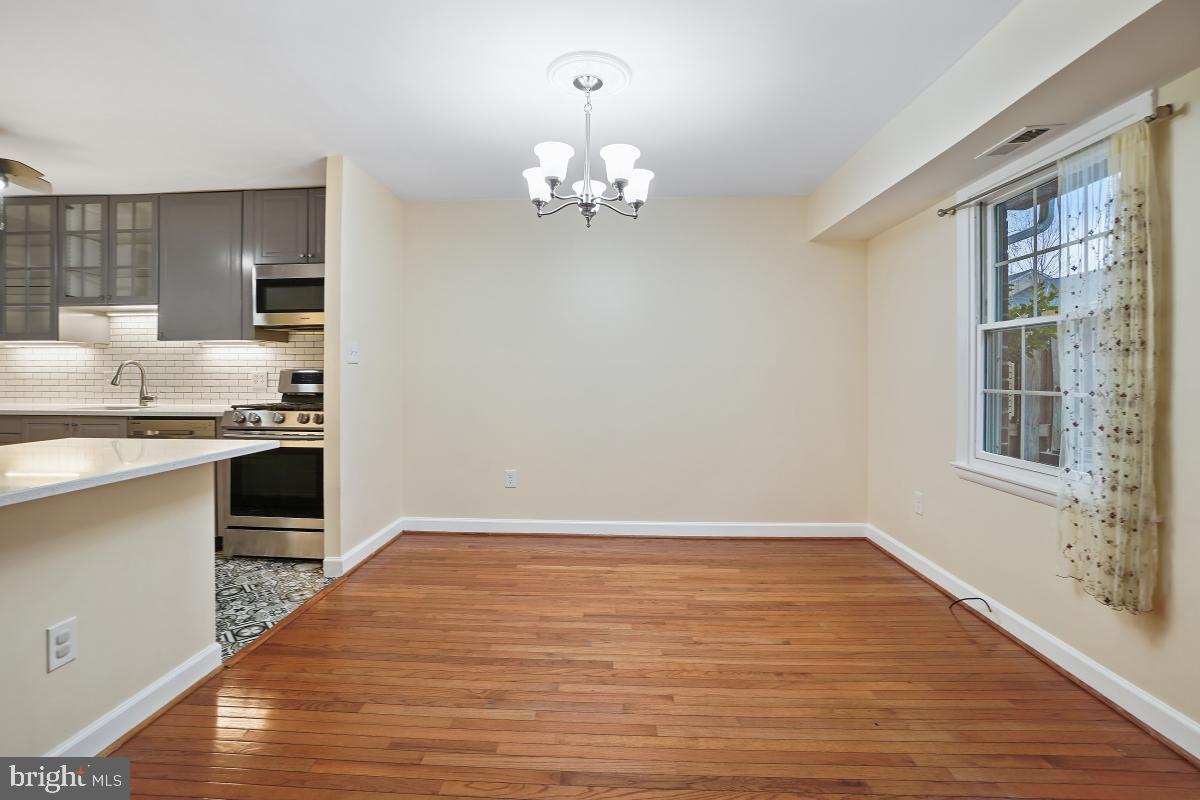 10867 Bucknell Drive, Unit 52 Silver Spring, MD 20902 - Photo 14 of 33 a view of kitchen with kitchen island wooden floor and refrigerator