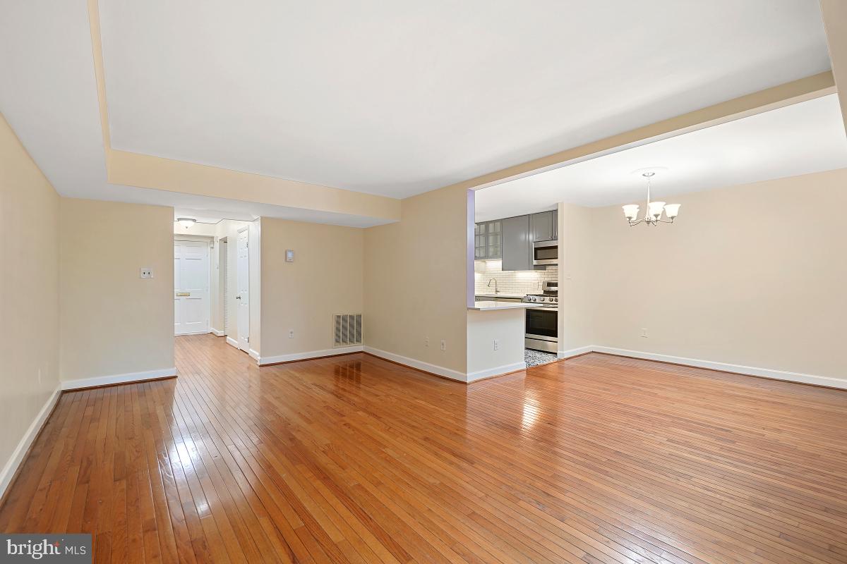 10867 Bucknell Drive, Unit 52 Silver Spring, MD 20902 - Photo 17 of 33 a view of a kitchen with wooden floor and a kitchen