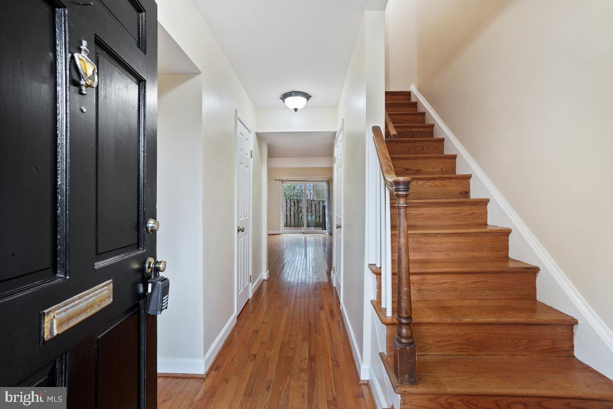 10867 Bucknell Drive, Unit 52 Silver Spring, MD 20902 - Photo 2 of 33 a view of a hallway with wooden floor and staircase