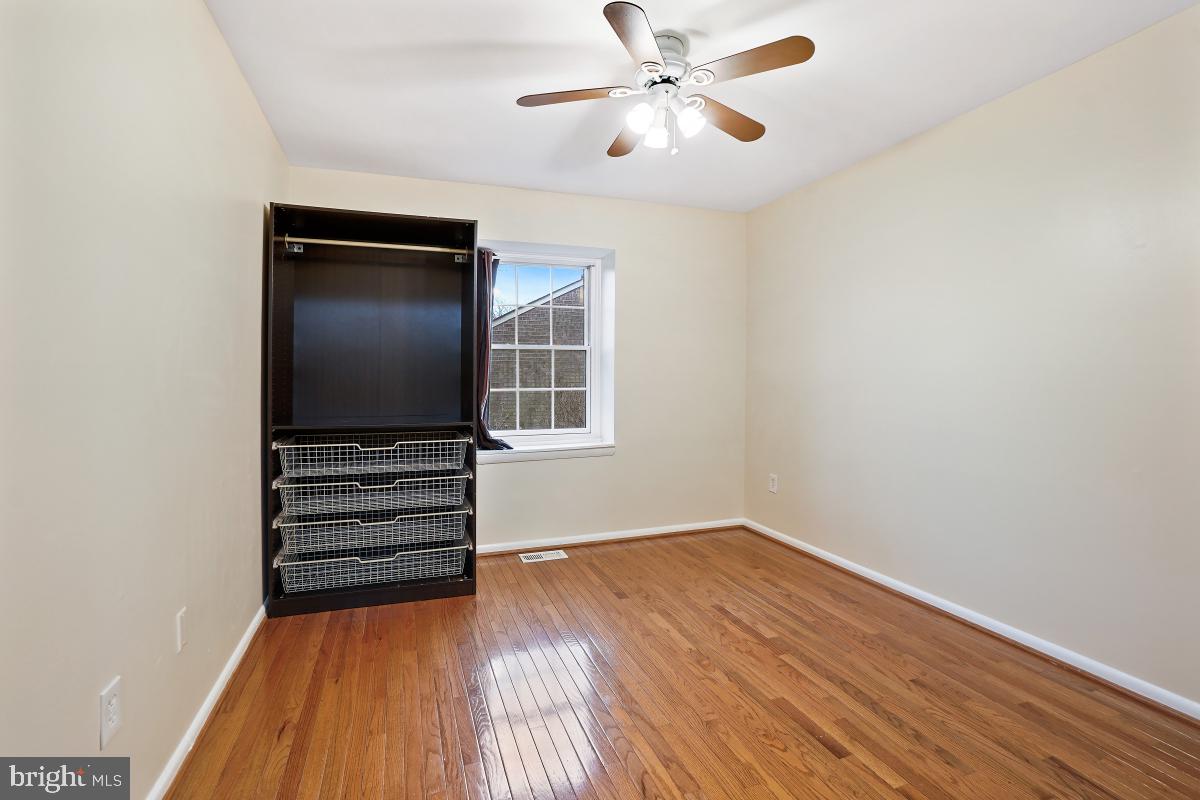 10867 Bucknell Drive, Unit 52 Silver Spring, MD 20902 - Photo 22 of 33 a view of empty room with wooden floor and fan