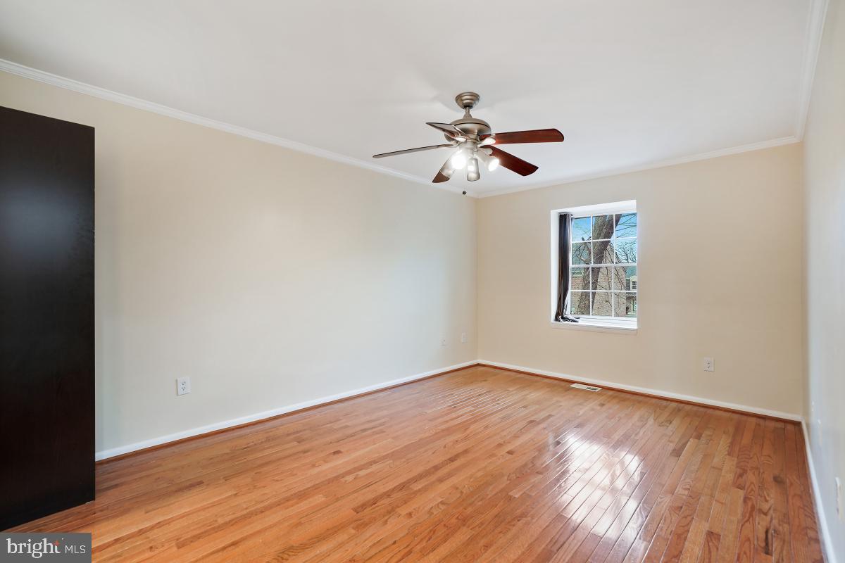 10867 Bucknell Drive, Unit 52 Silver Spring, MD 20902 - Photo 23 of 33 a view of empty room with wooden floor and fan