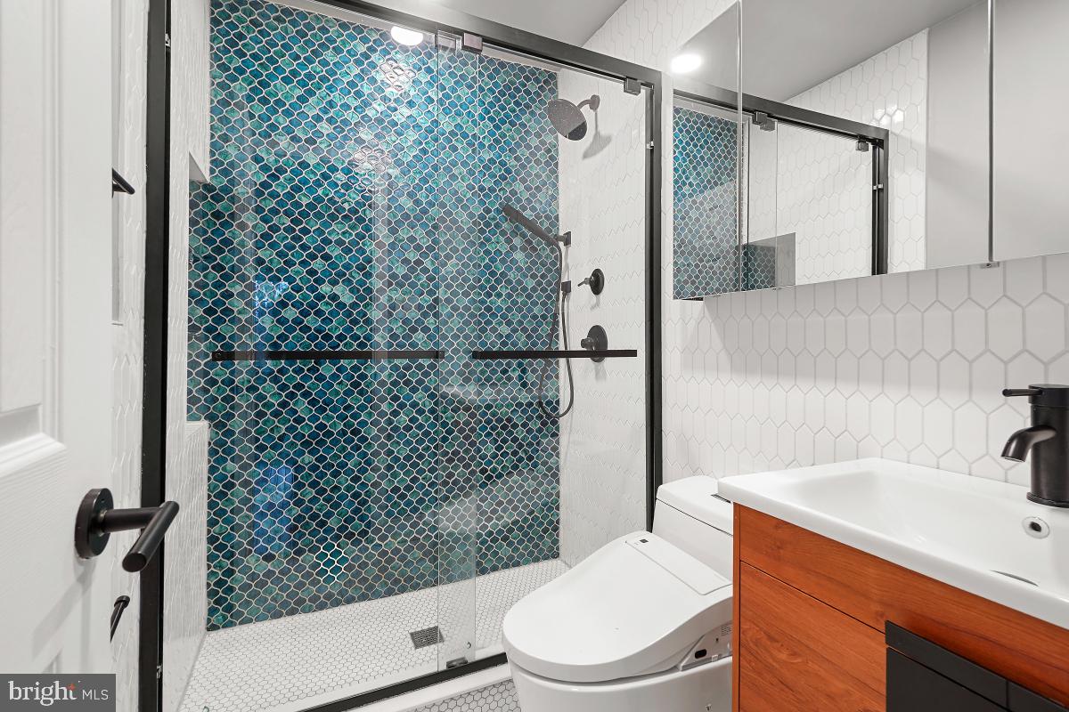 10867 Bucknell Drive, Unit 52 Silver Spring, MD 20902 - Photo 26 of 33 a bathroom with a sink a toilet and shower