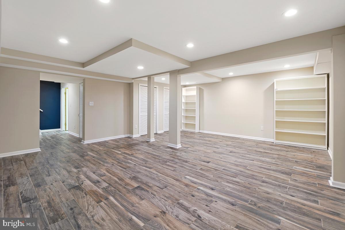 10867 Bucknell Drive, Unit 52 Silver Spring, MD 20902 - Photo 29 of 33 a view of an empty room with wooden floor and entryway