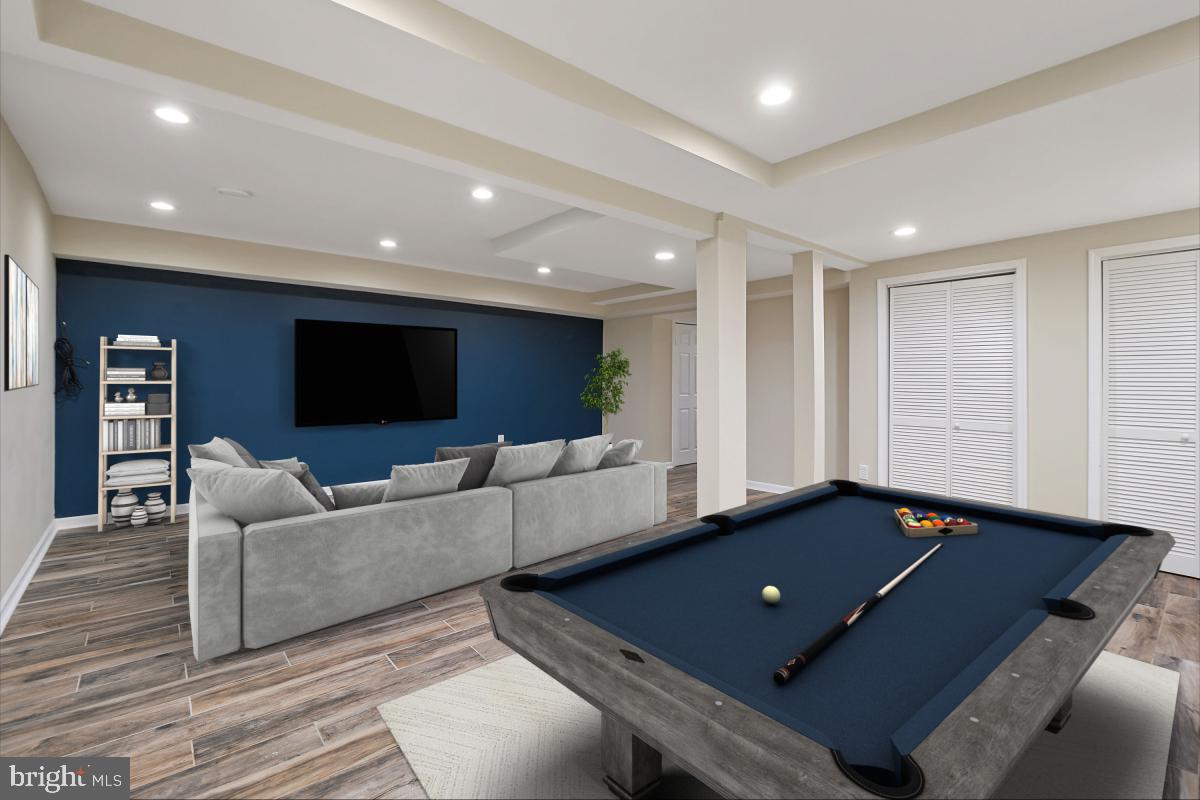 10867 Bucknell Drive, Unit 52 Silver Spring, MD 20902 - Photo 30 of 33 a living room with furniture and a flat screen tv