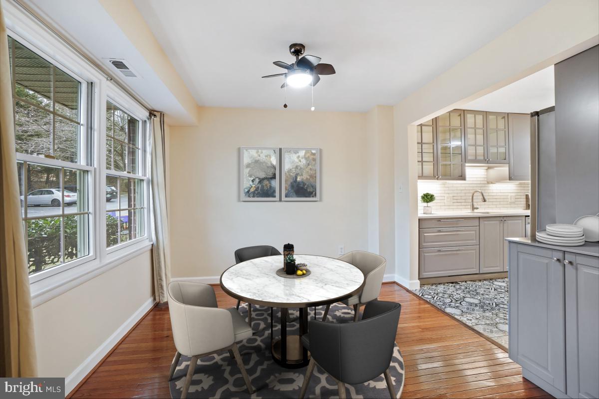 10867 Bucknell Drive, Unit 52 Silver Spring, MD 20902 - Photo 4 of 33 a dining room with furniture a window and wooden floor