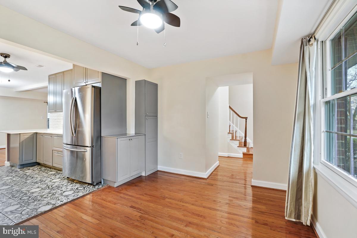 10867 Bucknell Drive, Unit 52 Silver Spring, MD 20902 - Photo 6 of 33 a kitchen with stainless steel appliances wooden floor and a refrigerator