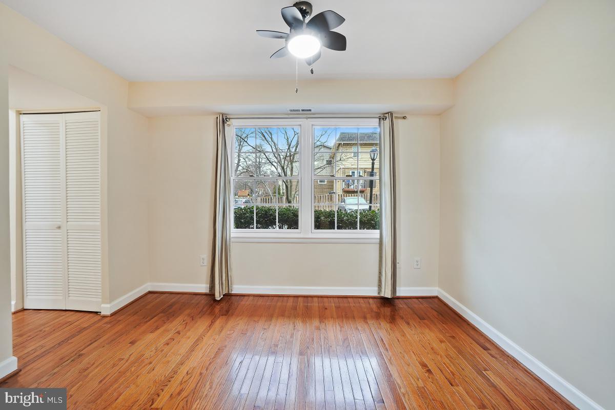 10867 Bucknell Drive, Unit 52 Silver Spring, MD 20902 - Photo 7 of 33 a view of empty room with wooden floor and fan