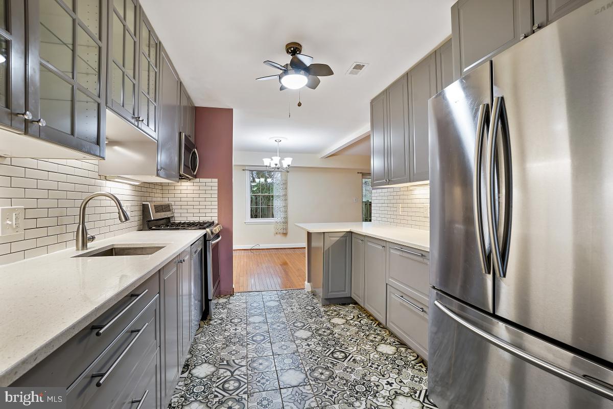 10867 Bucknell Drive, Unit 52 Silver Spring, MD 20902 - Photo 8 of 33 a kitchen with stainless steel appliances a refrigerator sink and stove