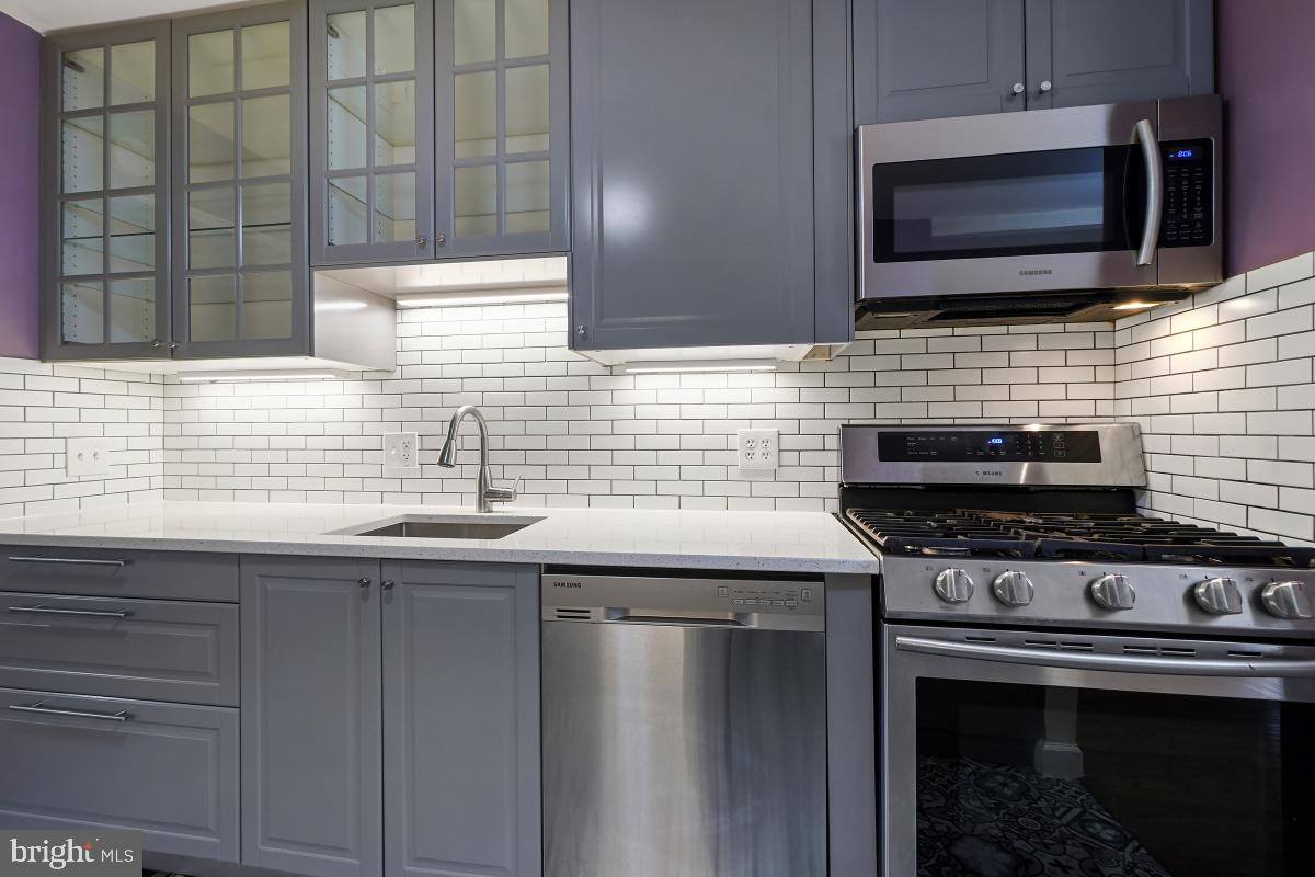 10867 Bucknell Drive, Unit 52 Silver Spring, MD 20902 - Photo 9 of 33 a kitchen with stainless steel appliances a sink stove and cabinets