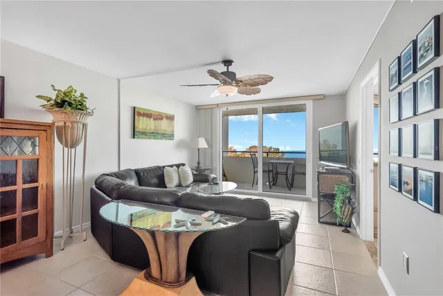 a living room with furniture a fireplace and a chandelier