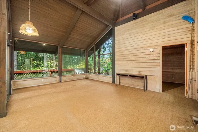 a view of an empty room with a fireplace and a large window