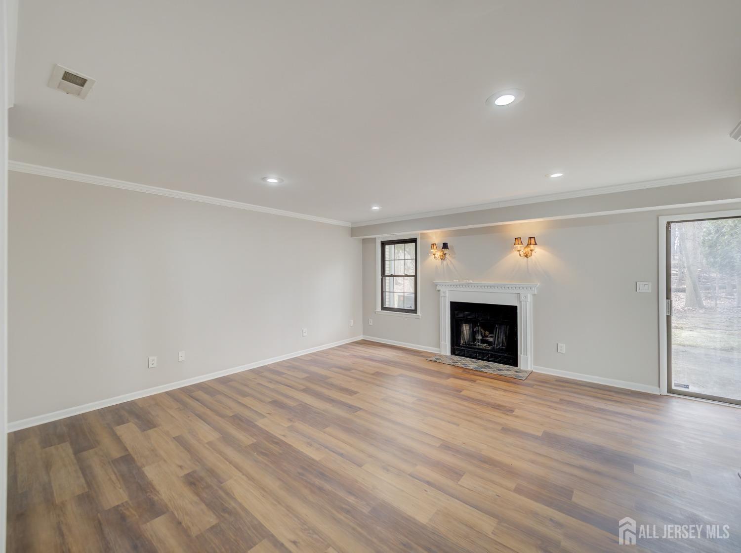 4905 Stonehedge Road Edison, NJ 08820 - Photo 13 of 43 a view of empty room with wooden floor and fireplace