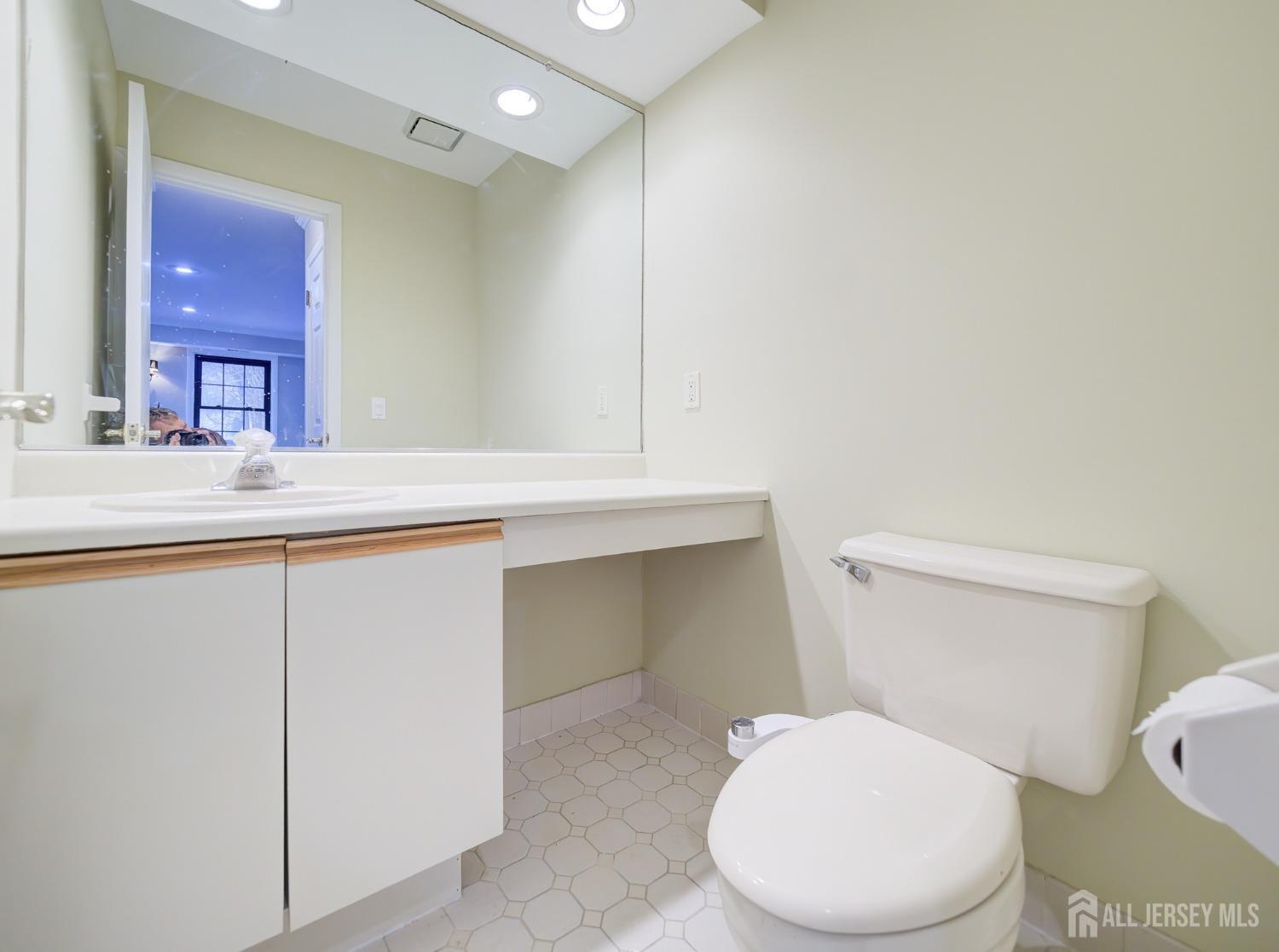 4905 Stonehedge Road Edison, NJ 08820 - Photo 17 of 43 a white toilet sitting next to a bathroom sink