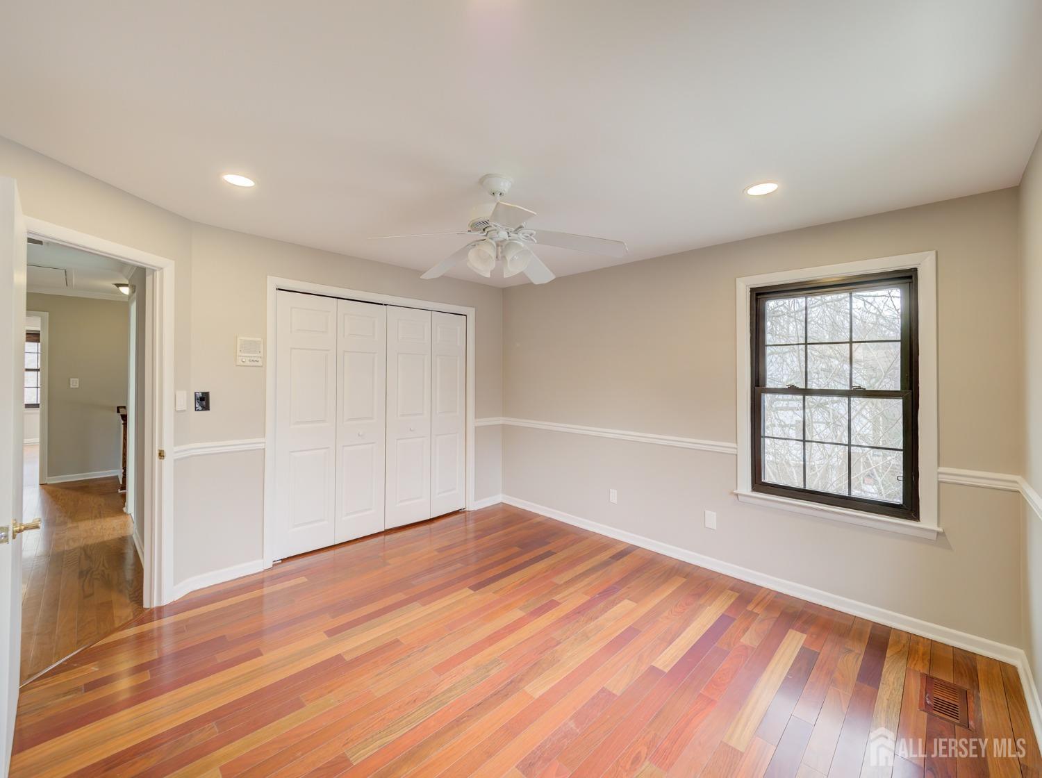 4905 Stonehedge Road Edison, NJ 08820 - Photo 22 of 43 wooden floor in an empty room with a window