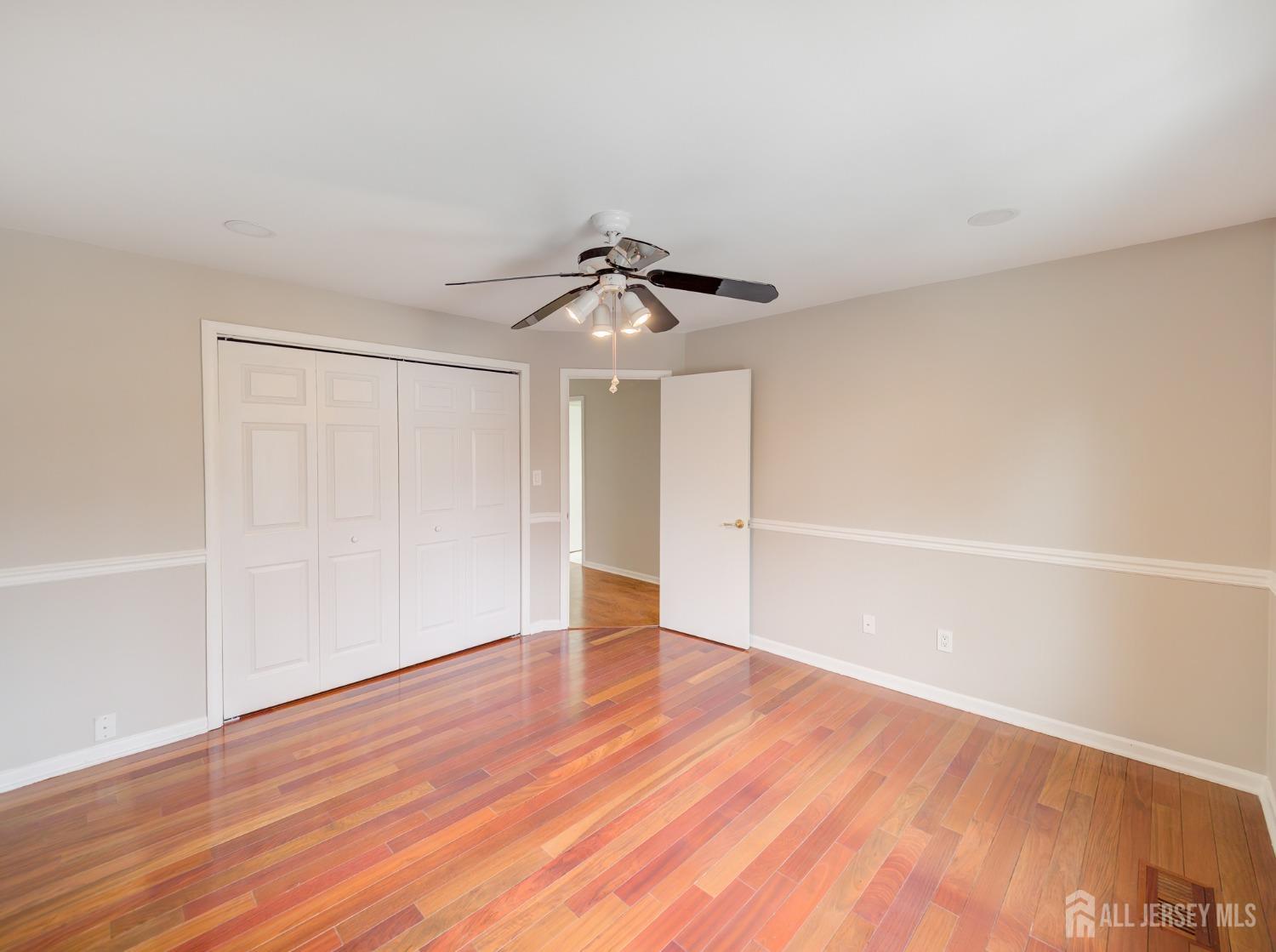 4905 Stonehedge Road Edison, NJ 08820 - Photo 24 of 43 a view of a room with wooden floor and white walls