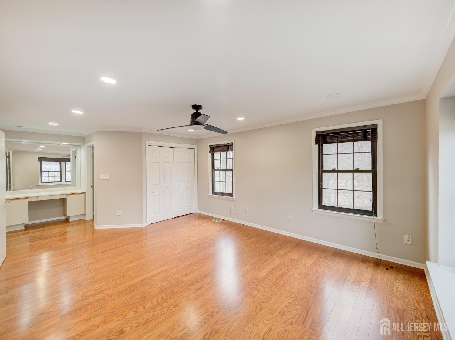 4905 Stonehedge Road Edison, NJ 08820 - Photo 25 of 43 a view of an empty room with window and wooden floor