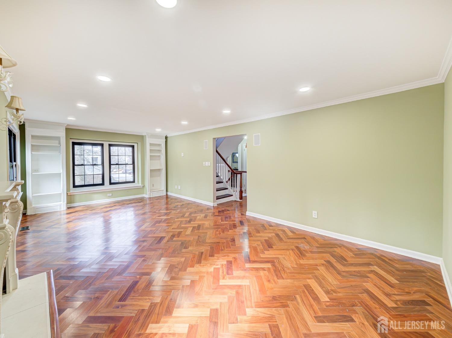 4905 Stonehedge Road Edison, NJ 08820 - Photo 27 of 43 a view of an empty room with window and wooden floor