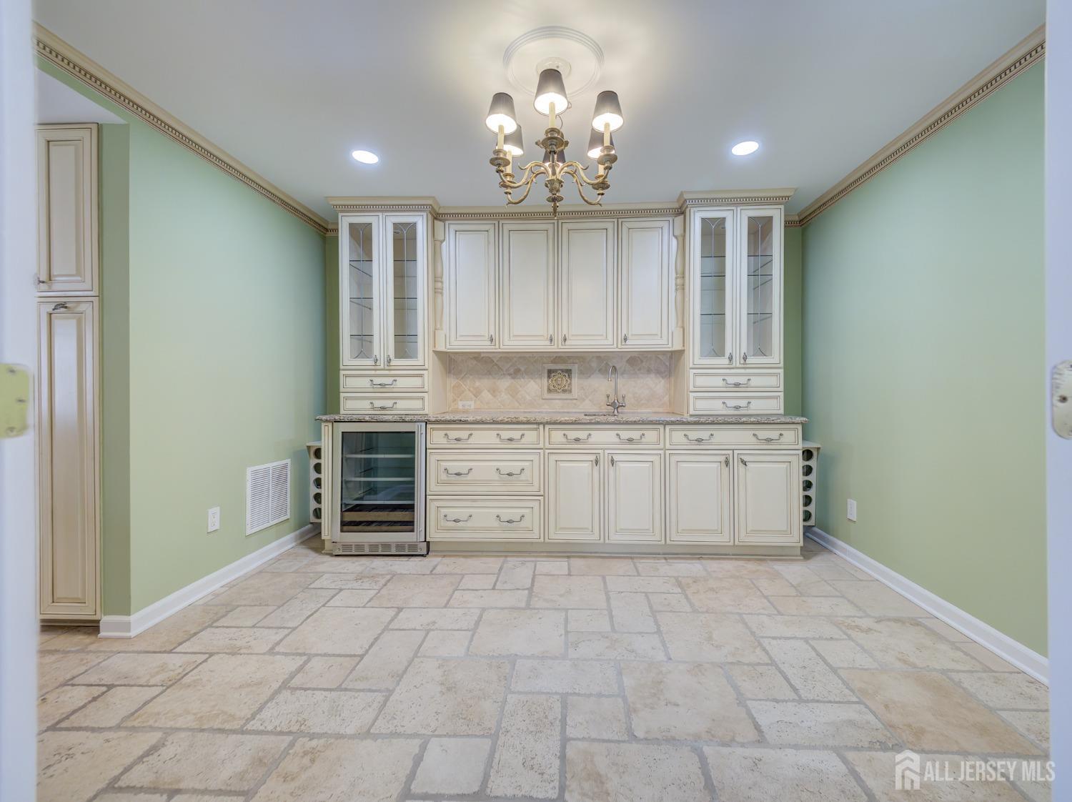 4905 Stonehedge Road Edison, NJ 08820 - Photo 3 of 43 a kitchen with stainless steel appliances a stove sink and cabinets