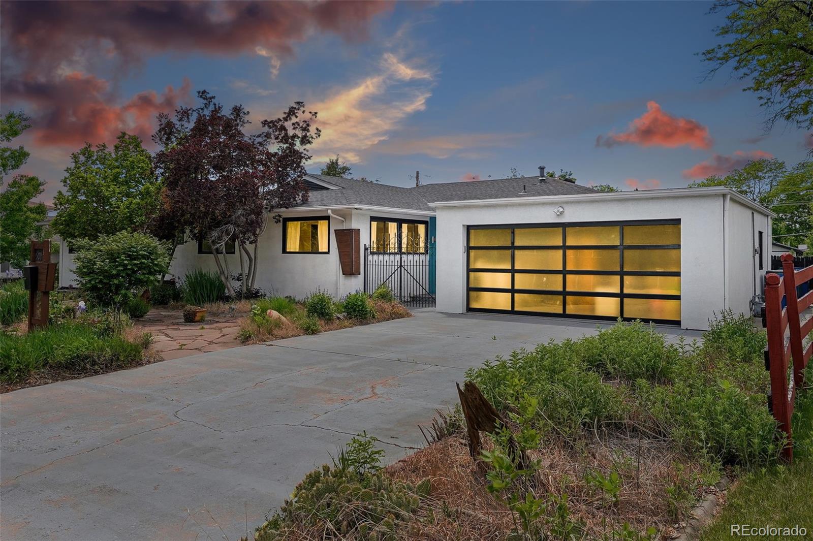 a front view of a house with a garden