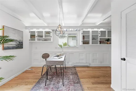 a front view of a house with wooden floor and dining table