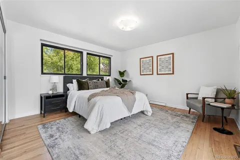 a bed room with a bed and a chair