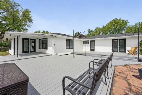 a view of a house with backyard and sitting area