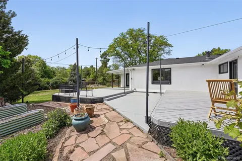 a view of a patio with chairs and potted plants