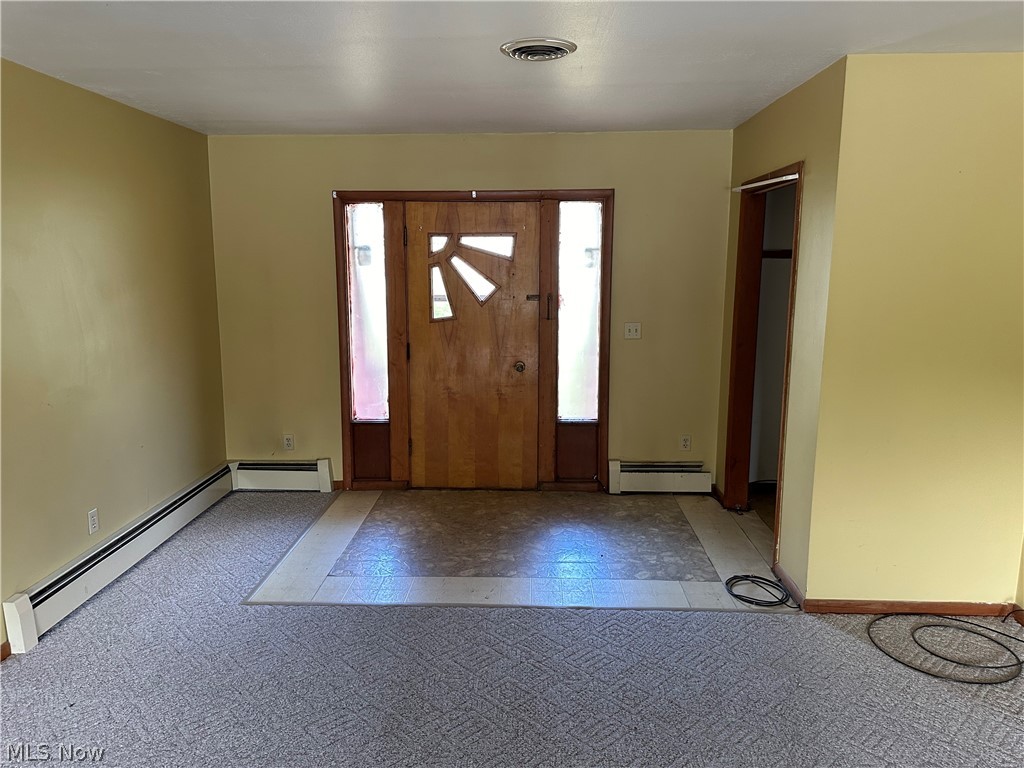 2288 Martin Road Mogadore, OH 44260 - Photo 6 of 27 Carpeted foyer entrance featuring a baseboard heating unit