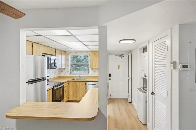 a large white kitchen with a large window