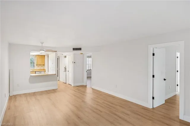 a view of an empty room and a window