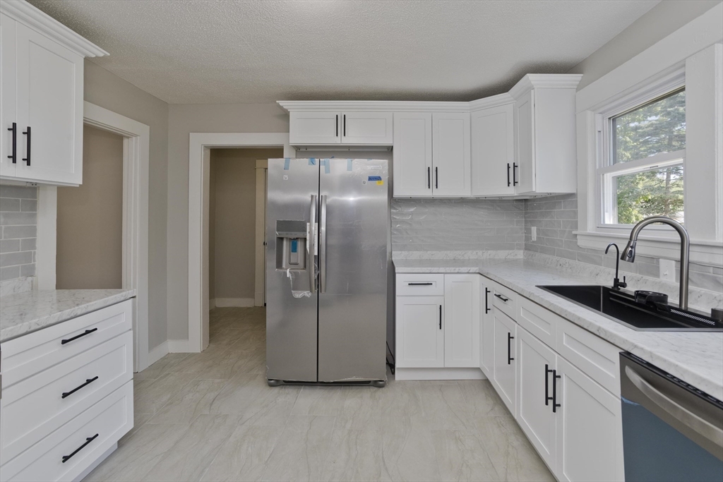 69 Merrimac Avenue Springfield, MA 01104 - Photo 1 of 42 a kitchen with a refrigerator sink and cabinets