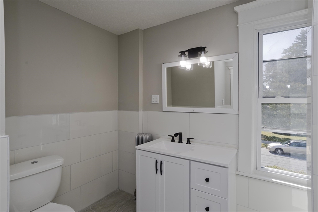 69 Merrimac Avenue Springfield, MA 01104 - Photo 11 of 42 a bathroom with a sink and a mirror