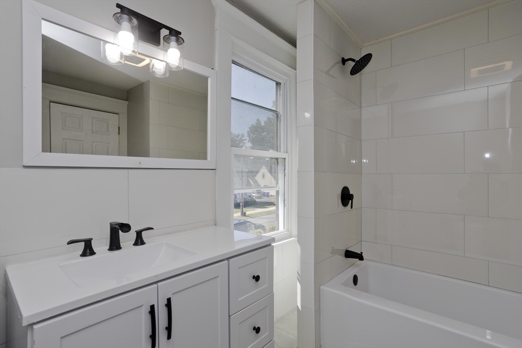69 Merrimac Avenue Springfield, MA 01104 - Photo 13 of 42 a bathroom with a sink and a mirror