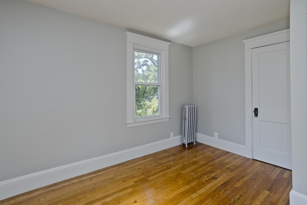 69 Merrimac Avenue Springfield, MA 01104 - Photo 15 of 42 a view of empty room with wooden floor and fan