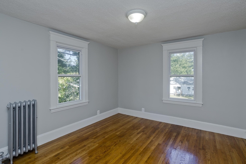 69 Merrimac Avenue Springfield, MA 01104 - Photo 16 of 42 a view of an empty room with wooden floor and a window