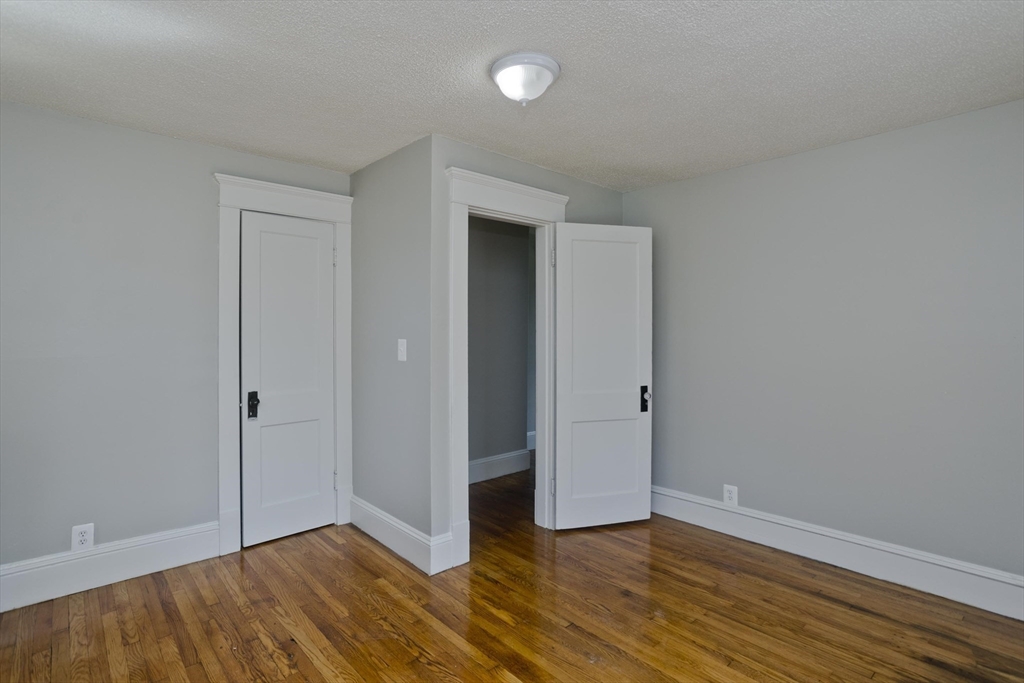 69 Merrimac Avenue Springfield, MA 01104 - Photo 17 of 42 a view of an empty room with wooden floor