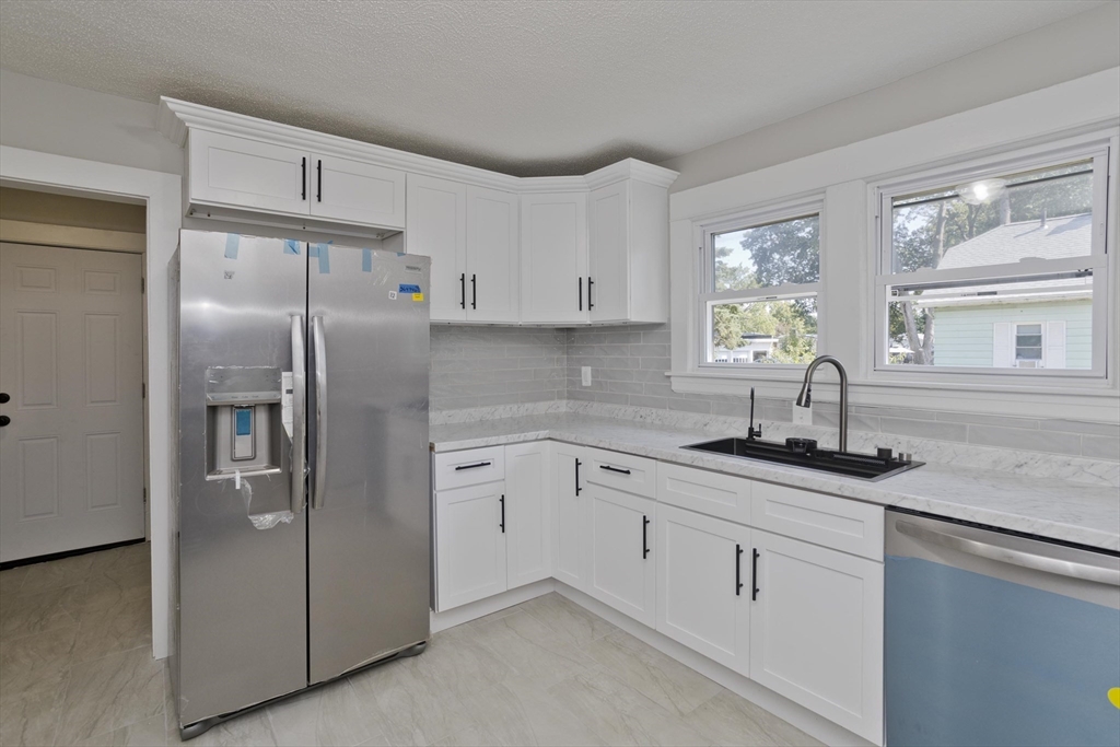 69 Merrimac Avenue Springfield, MA 01104 - Photo 2 of 42 a kitchen with appliances cabinets and a sink