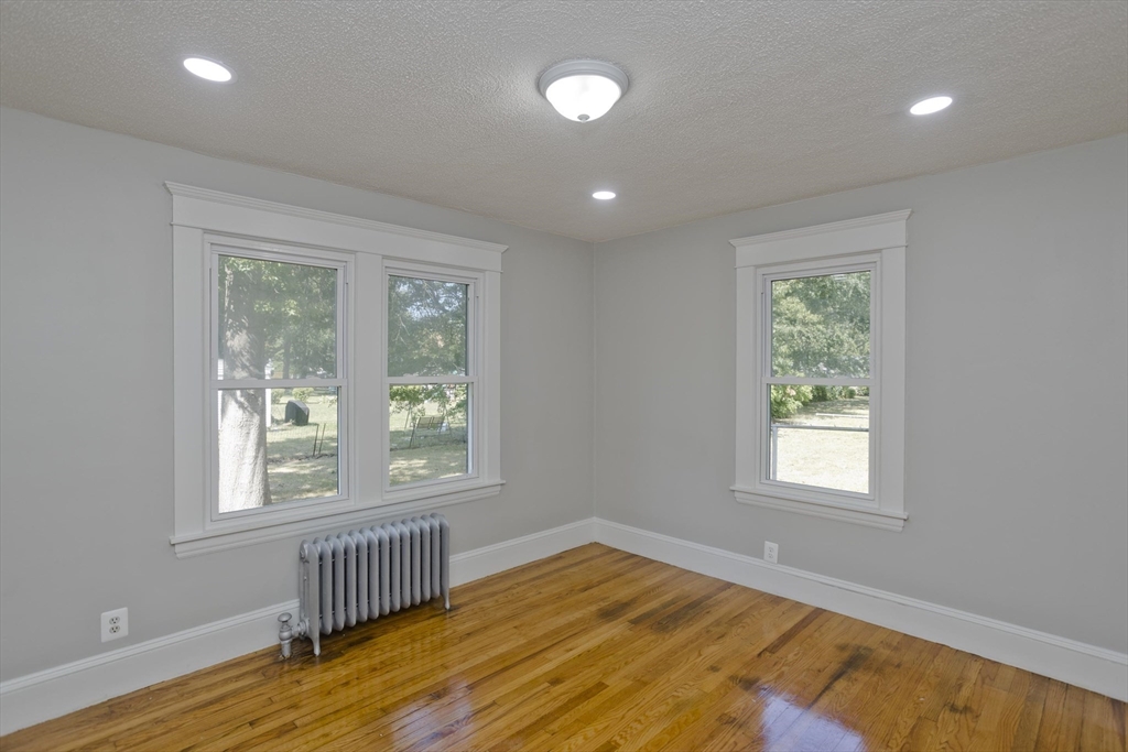 69 Merrimac Avenue Springfield, MA 01104 - Photo 24 of 42 a view of an empty room with wooden floor and a window