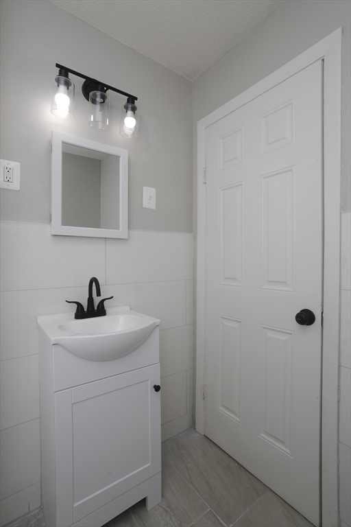 69 Merrimac Avenue Springfield, MA 01104 - Photo 28 of 42 a bathroom with a sink a toilet and mirror