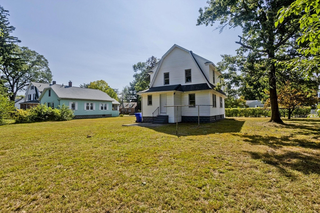 69 Merrimac Avenue Springfield, MA 01104 - Photo 35 of 42 a front view of a house with a yard