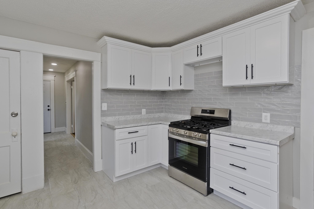 69 Merrimac Avenue Springfield, MA 01104 - Photo 4 of 42 a kitchen with cabinets appliances and a sink