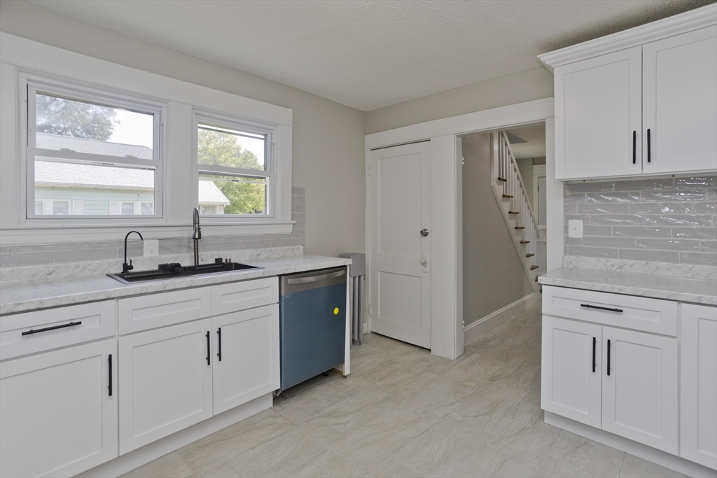 69 Merrimac Avenue Springfield, MA 01104 - Photo 5 of 42 a kitchen with white cabinets and sink