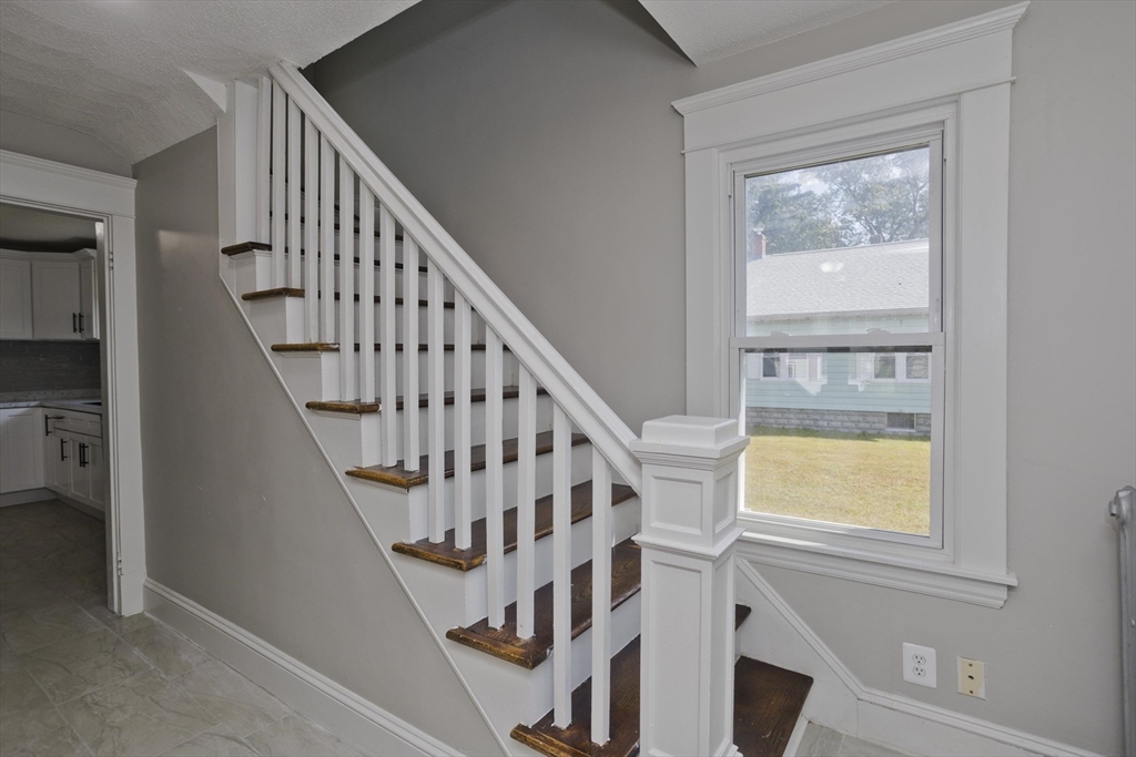 69 Merrimac Avenue Springfield, MA 01104 - Photo 9 of 42 a view of staircase with wooden floor and a window