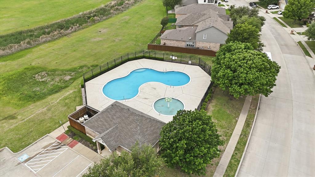 11500 Starlight Ranch Fort Worth, TX 76052 - Photo 38 of 40 Community amenities include a fenced swimming pool with a distinct shape and a circular fountain feature