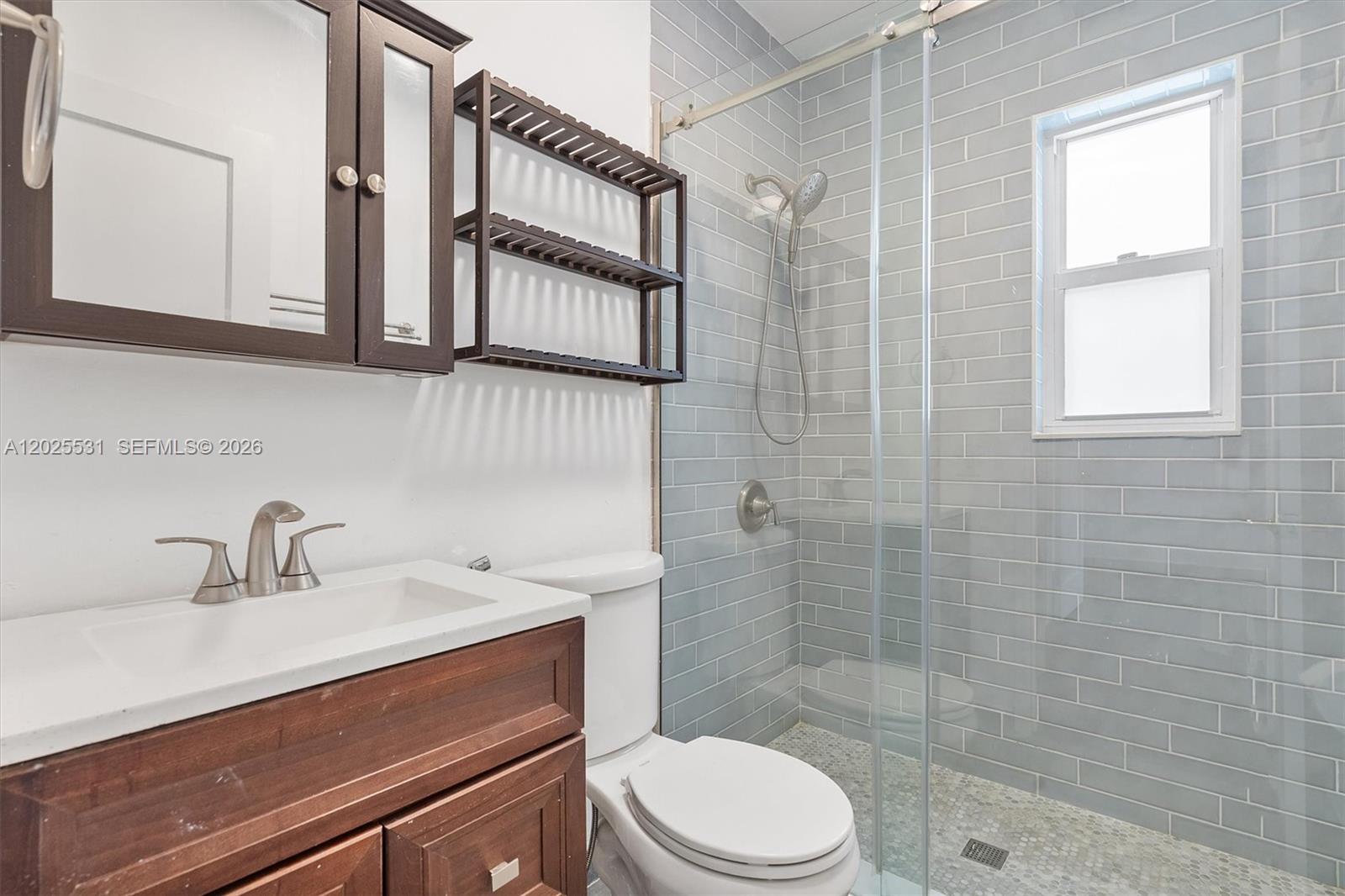 3951 Southwest 2nd Terrace, Unit 3951 Miami, FL 33134 - Photo 9 of 21 a bathroom with a sink a toilet and shower