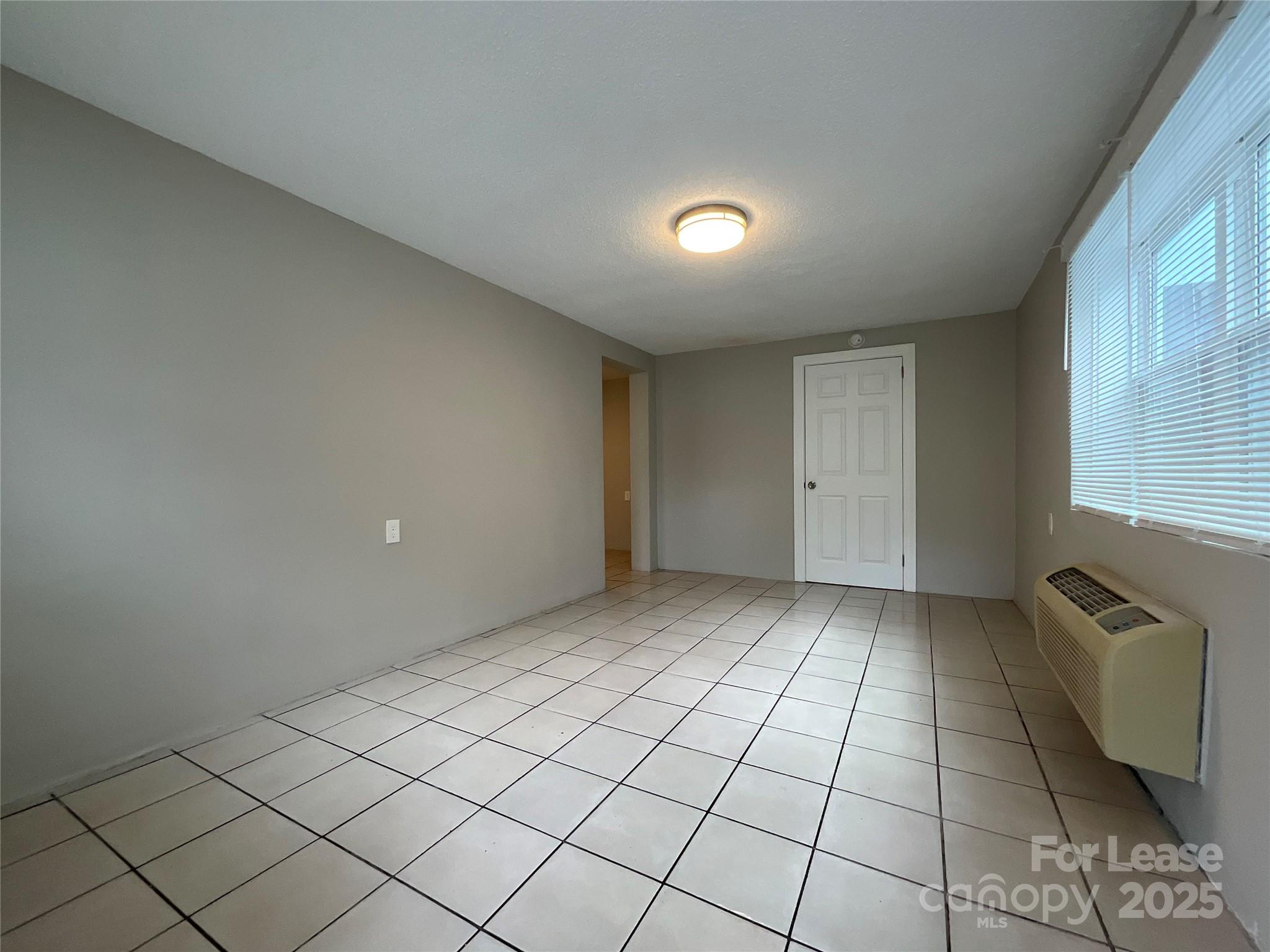 259 Jefferson Court Northeast, Unit 1 Concord, NC 28025 - Photo 2 of 9 a view of an empty room and window