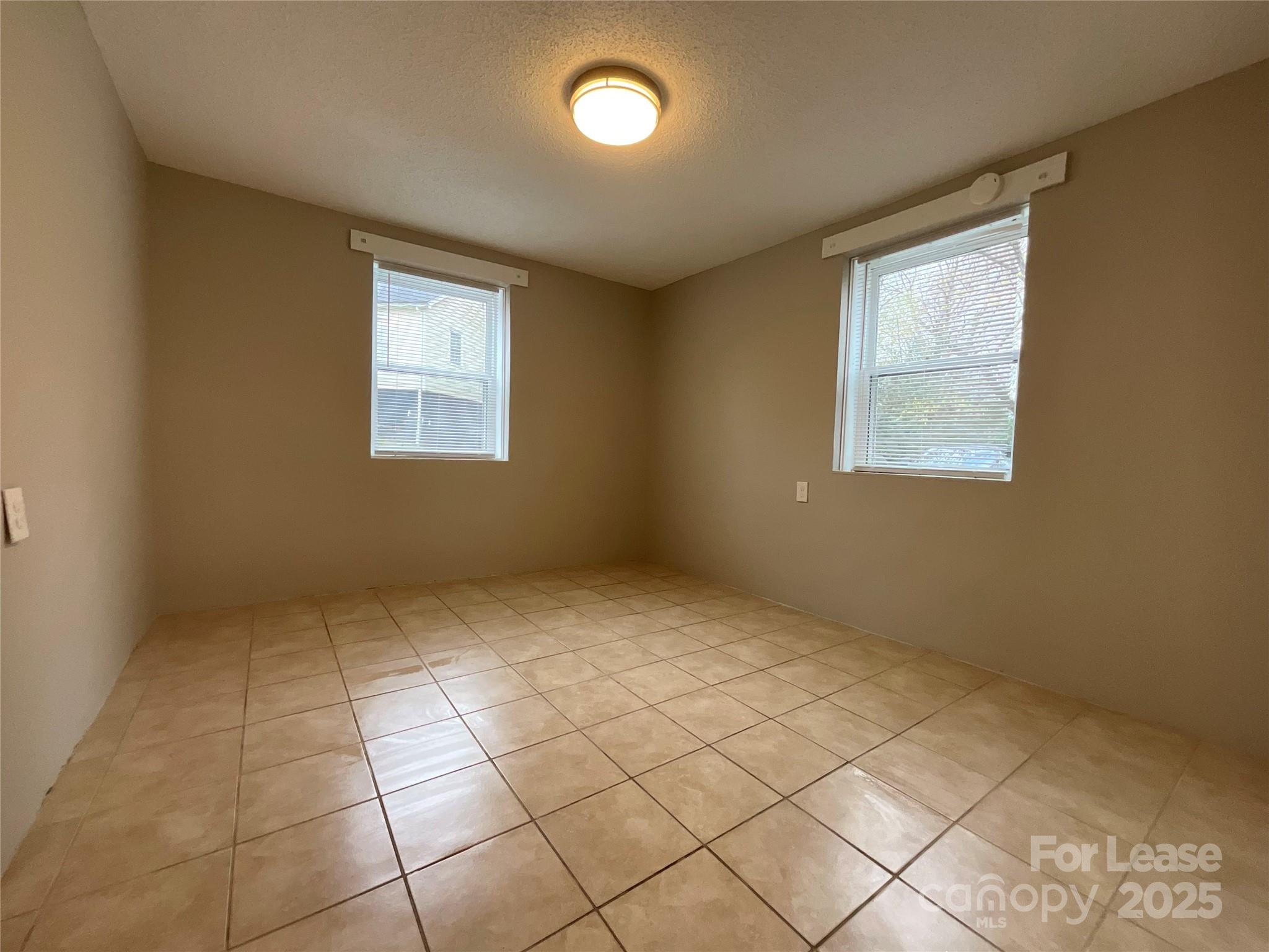 259 Jefferson Court Northeast, Unit 1 Concord, NC 28025 - Photo 8 of 9 a view of an empty room with a window